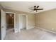 Cozy bedroom boasts a ceiling fan, soft carpeting, and a convenient closet at 772 Vinings Estates Se Dr, Mableton, GA 30126