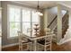 Cozy dining area filled with natural light with hardwood floors and access to the staircase at 772 Vinings Estates Se Dr, Mableton, GA 30126