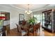 Beautiful dining room with hardwood floors, a chandelier, and a large window for natural light at 772 Vinings Estates Se Dr, Mableton, GA 30126