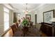 Spacious dining room featuring a large table, hardwood floors, and decorative lighting at 772 Vinings Estates Se Dr, Mableton, GA 30126