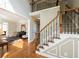 Sunlit foyer featuring hardwood floors and an elegant staircase leading to the second floor of the home at 772 Vinings Estates Se Dr, Mableton, GA 30126