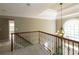 Elegant foyer with chandelier, wrought iron staircase, and large window that brings in natural light at 772 Vinings Estates Se Dr, Mableton, GA 30126