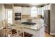 Charming kitchen with stainless steel appliances, granite counters, hardwood floors, and an eat-in island at 772 Vinings Estates Se Dr, Mableton, GA 30126
