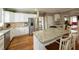 Open kitchen featuring white cabinets, granite countertops, stainless steel appliances and a breakfast bar with seating at 772 Vinings Estates Se Dr, Mableton, GA 30126