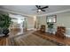 Open-concept living room with hardwood floors, neutral paint, large rug, and a view into the kitchen at 772 Vinings Estates Se Dr, Mableton, GA 30126