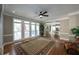 Spacious living room boasts hardwood floors, lots of windows, and views of the staircase and kitchen at 772 Vinings Estates Se Dr, Mableton, GA 30126