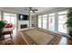 Living room featuring hardwood floors, neutral paint, built-in shelving, fireplace and large windows at 772 Vinings Estates Se Dr, Mableton, GA 30126