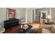 Cozy living room featuring hardwood floors, comfortable seating, and an artistic piano at 772 Vinings Estates Se Dr, Mableton, GA 30126