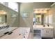 Main bath featuring a soaking tub, double vanity and oversized mirror at 772 Vinings Estates Se Dr, Mableton, GA 30126