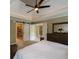 Spacious main bedroom with tray ceiling, fan, and sliding barn door to closet at 772 Vinings Estates Se Dr, Mableton, GA 30126
