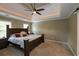 Comfortable main bedroom with plush carpet, fan and trey ceiling and lots of light at 772 Vinings Estates Se Dr, Mableton, GA 30126