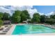 Large community pool with slide, surrounding chairs, and shaded lounge areas for relaxation at 772 Vinings Estates Se Dr, Mableton, GA 30126