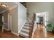 Foyer with hardwood flooring, staircase with carpet, and dining room in the background at 772 Vinings Estates Se Dr, Mableton, GA 30126