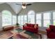 Bright sunroom with vaulted ceilings, large windows, and a ceiling fan, perfect for relaxation at 772 Vinings Estates Se Dr, Mableton, GA 30126