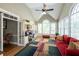 Bright office sunroom with vaulted ceilings, large windows, built-in desk, and hardwood floors at 772 Vinings Estates Se Dr, Mableton, GA 30126