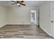 Bedroom with gray walls and wood laminate flooring, leading to a doorway to the kitchen at 1335 Jamestowne Trl, Alpharetta, GA 30009