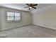 Spacious bedroom features carpeted floors, modern ceiling fan, and a large window at 1335 Jamestowne Trl, Alpharetta, GA 30009