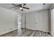 Bedroom featuring a ceiling fan and two closet doors on a light gray wall at 1335 Jamestowne Trl, Alpharetta, GA 30009