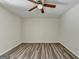 Bedroom with ceiling fan and open layout featuring light gray walls and laminate wood flooring at 1335 Jamestowne Trl, Alpharetta, GA 30009