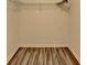 Walk-in closet with wood-look flooring, wire racks, and new paint at 1335 Jamestowne Trl, Alpharetta, GA 30009