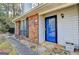 A home entrance featuring stone walkway, a bright blue front door, and well maintained landscaping at 1335 Jamestowne Trl, Alpharetta, GA 30009