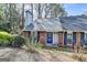 Charming townhome featuring a brick facade, well-maintained landscaping and a vibrant blue door at 1335 Jamestowne Trl, Alpharetta, GA 30009