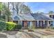 Charming home featuring a brick facade, mature landscaping and a prominent chimney at 1335 Jamestowne Trl, Alpharetta, GA 30009