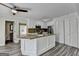 Kitchen island with granite counters and white cabinets opens to rooms down the hall at 1335 Jamestowne Trl, Alpharetta, GA 30009