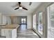 Eat-in kitchen with stainless appliances and breakfast area featuring many windows and a ceiling fan at 1335 Jamestowne Trl, Alpharetta, GA 30009