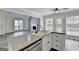 Kitchen island with sink overlooks the living room with fireplace at 1335 Jamestowne Trl, Alpharetta, GA 30009