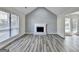 Spacious living room with vaulted ceilings, fireplace, hardwood flooring and backyard access at 1335 Jamestowne Trl, Alpharetta, GA 30009