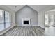 Spacious living room with vaulted ceilings, fireplace, hardwood flooring and backyard access at 1335 Jamestowne Trl, Alpharetta, GA 30009