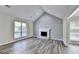 Spacious living room with vaulted ceilings, fireplace, hardwood flooring and large windows at 1335 Jamestowne Trl, Alpharetta, GA 30009