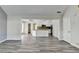 Open floor plan with wood-look floors connecting the living room to the kitchen space at 1335 Jamestowne Trl, Alpharetta, GA 30009