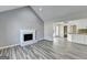 Bright and airy living room featuring a fireplace and seamlessly flows into the adjacent kitchen area at 1335 Jamestowne Trl, Alpharetta, GA 30009