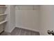 This walk-in closet features shelving and soft, gray carpeting at 1335 Jamestowne Trl, Alpharetta, GA 30009