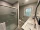 Bathroom featuring double vanity, sliding glass door shower, and tiled floor at 1888 Peeler Rd, Dunwoody, GA 30338