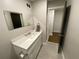 Updated half bathroom featuring a single sink vanity and gray tile flooring at 1888 Peeler Rd, Dunwoody, GA 30338