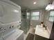 Full bathroom with glass-door shower, modern fixtures, and stacked washer/dryer at 1888 Peeler Rd, Dunwoody, GA 30338