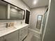 Modern bathroom with a double vanity, a large mirror, and a glass door shower at 1888 Peeler Rd, Dunwoody, GA 30338