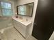 Bathroom with a double sink vanity, black framed mirror and natural light from the window at 1888 Peeler Rd, Dunwoody, GA 30338