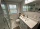 Bathroom features marble flooring, glass enclosed shower, and white vanity at 1888 Peeler Rd, Dunwoody, GA 30338