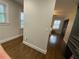 Hallway to a bedroom with hardwood floors, two windows, and a closet with organization system at 1888 Peeler Rd, Dunwoody, GA 30338