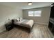 Bright bedroom with grey floors, closet, and neutral-toned linens at 1888 Peeler Rd, Dunwoody, GA 30338