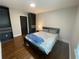 Bedroom with wood floors, a queen bed, black accent wardrobes and natural light at 1888 Peeler Rd, Dunwoody, GA 30338