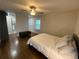 Bedroom featuring hardwood floors, a bench, a queen size bed, and an ensuite bathroom at 1888 Peeler Rd, Dunwoody, GA 30338