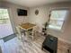 Dining area with a wooden table, four chairs, and a sliding glass door leading to the deck at 1888 Peeler Rd, Dunwoody, GA 30338