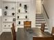 Dining room featuring wood table, chairs, built in shelves, and staircase at 1888 Peeler Rd, Dunwoody, GA 30338