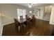 Traditional dining room with hardwood floors, dining table, and access to a screened-in porch and built-in shelves at 1888 Peeler Rd, Dunwoody, GA 30338