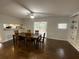 Dining room with a ceiling fan, hardwood floors, and access to the kitchen and a screened-in porch at 1888 Peeler Rd, Dunwoody, GA 30338